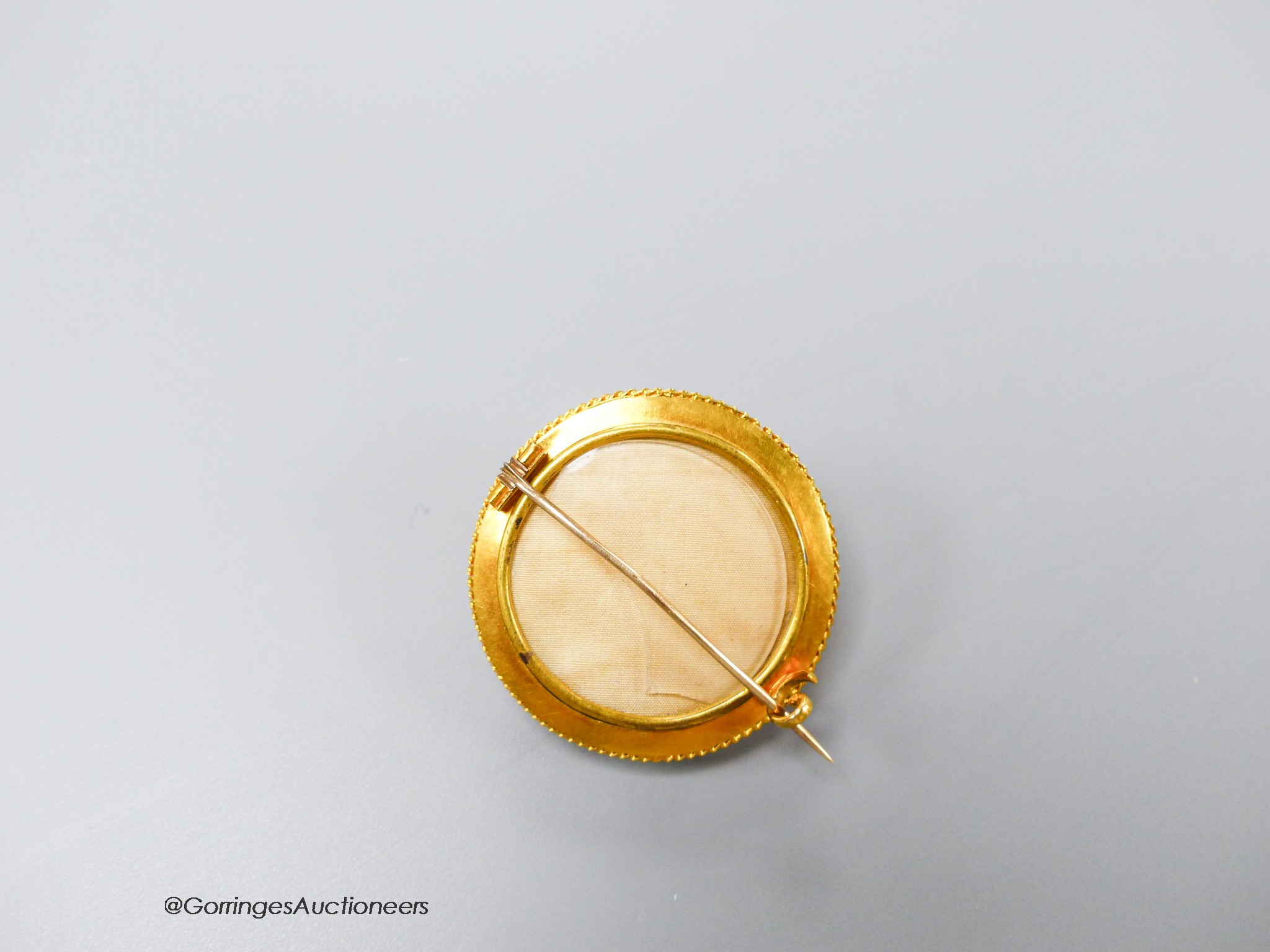 A Victorian yellow metal and ten stone garnet set cannetile work circular brooch, 39mm, gross 17.9 grams.